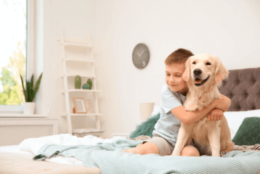 Boy hugging Golden Retriever