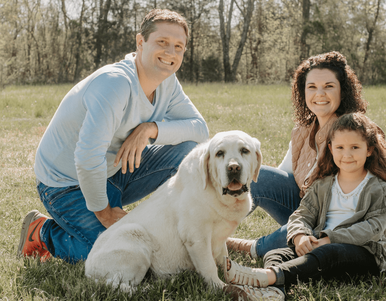 Tom and Adult White Lab Posing For Camera in a field of grass